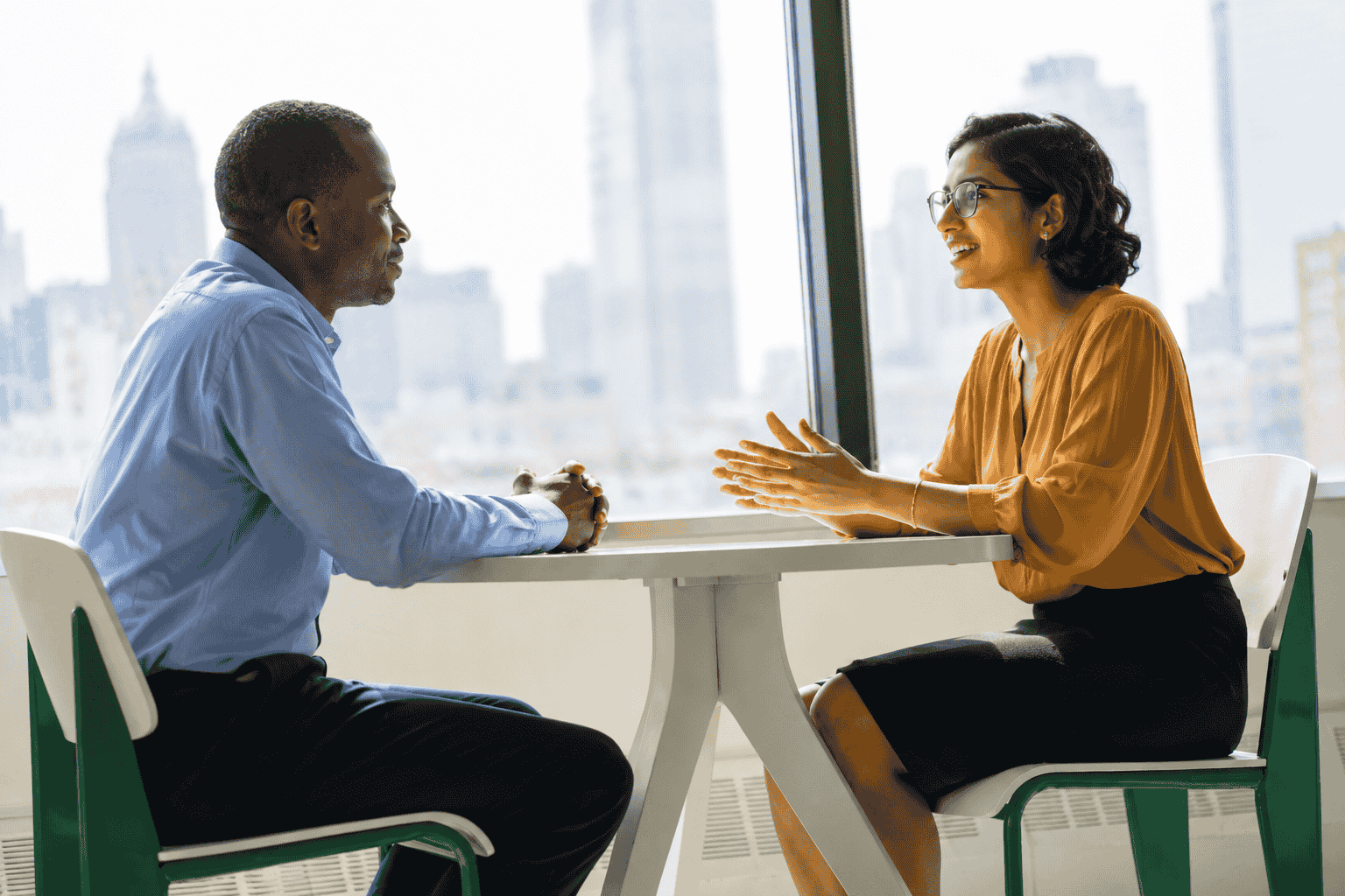 Support professional working with a learner at a table